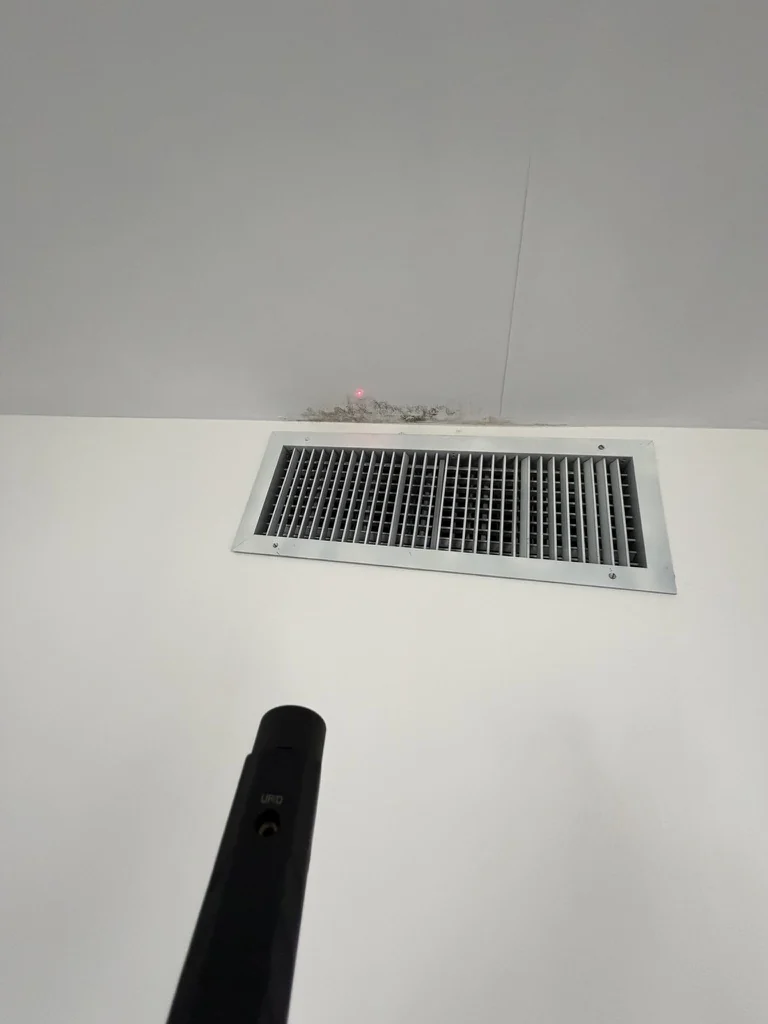 Discoloration around a residential HVAC supply register during inspection