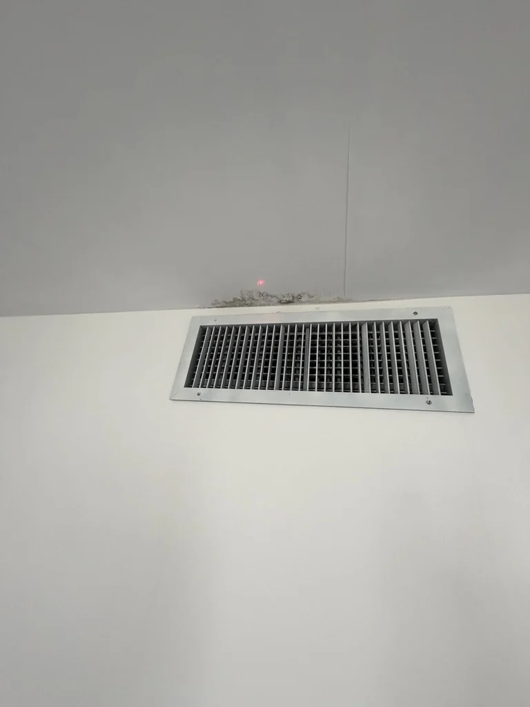 Visible discoloration above an air-conditioning supply grille