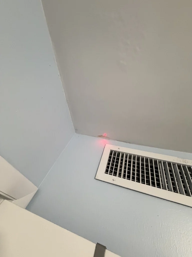 Localized discoloration at the wall and ceiling near an HVAC register