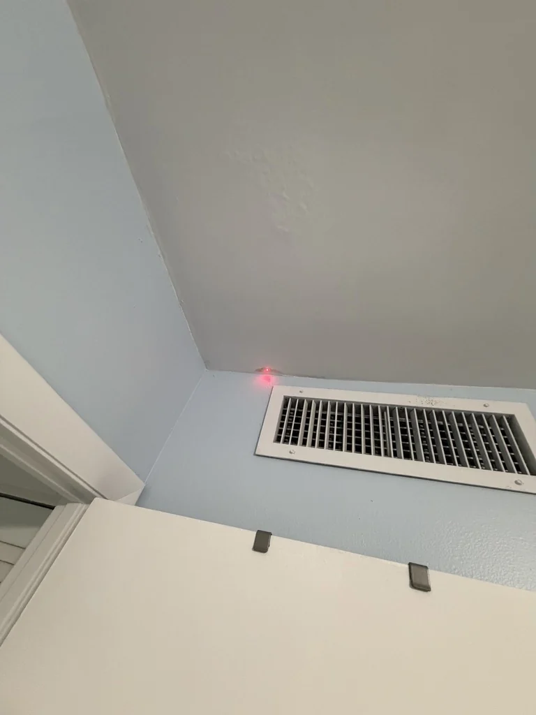 Wider view of an HVAC supply register and surrounding ceiling area