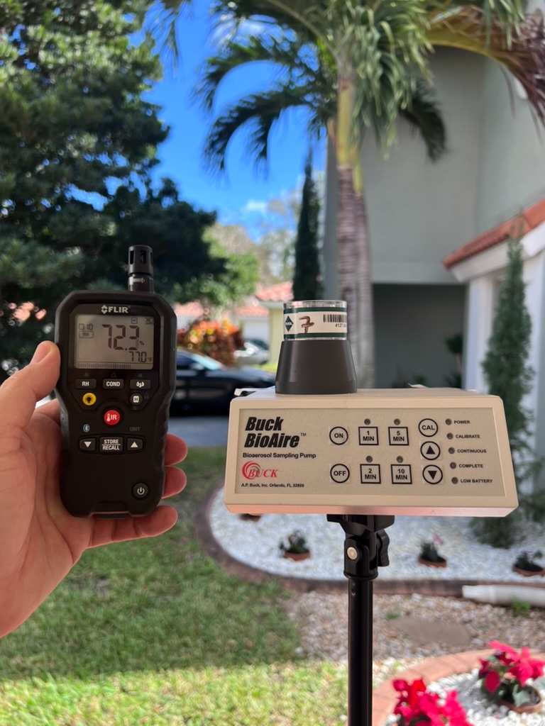 FLIR moisture meter and Buck BioAire sampling pump set up outside a South Florida home