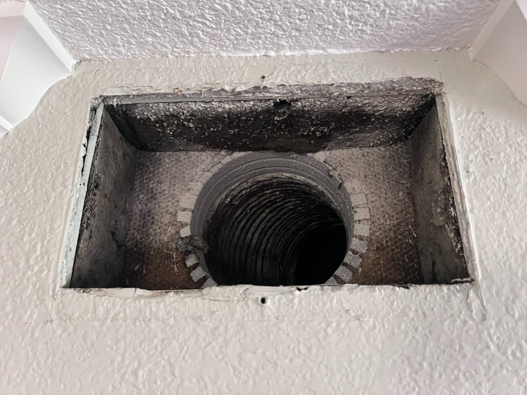 Interior view of a heavily soiled dryer or HVAC duct opening